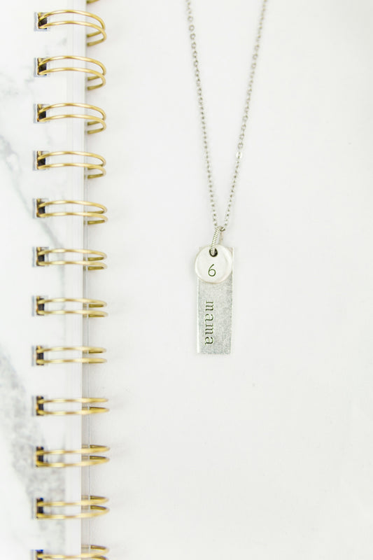 silver key chain on white paper