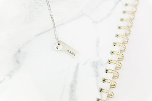 silver key chain on white textile