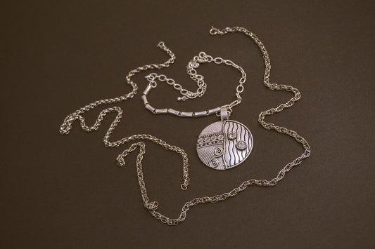 a close up of a necklace on a table