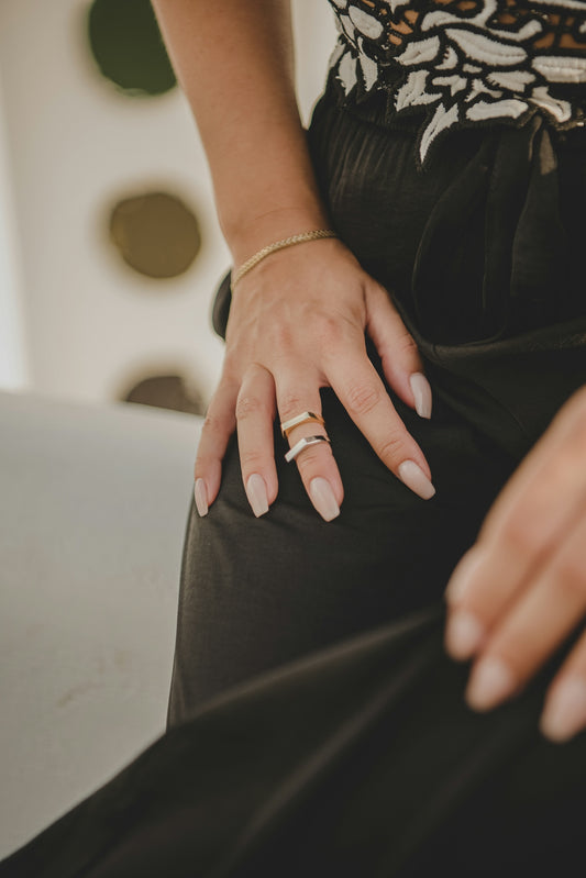 a woman's hand with a ring on her finger