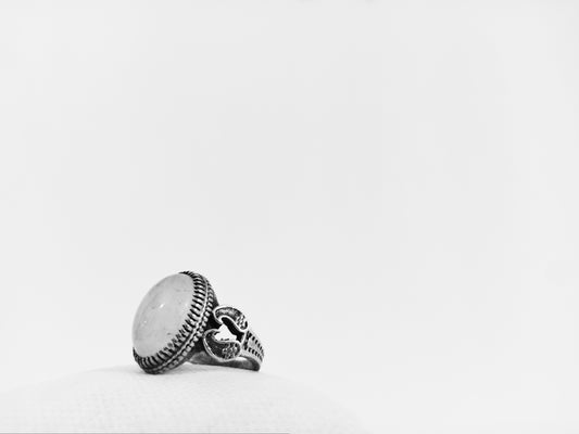 a black and white photo of a ring