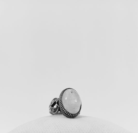 a white ring sitting on top of a pillow