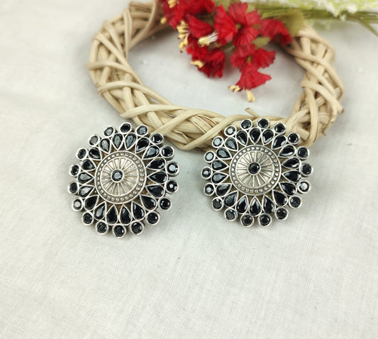 a pair of earrings sitting on top of a table