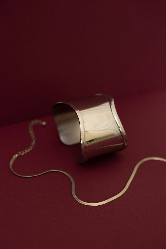 A silver object is on a red surface