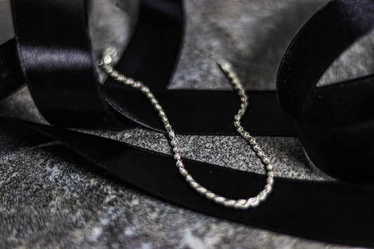 A pair of headphones sitting on top of a black ribbon