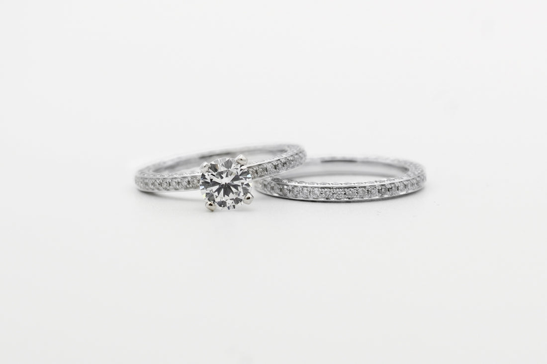 silver diamond studded ring on white surface