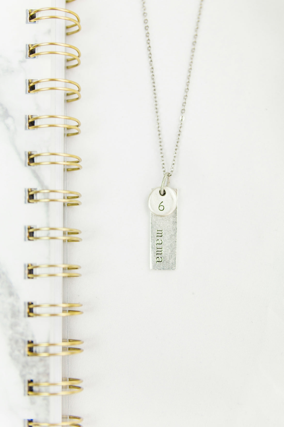 silver key chain on white paper