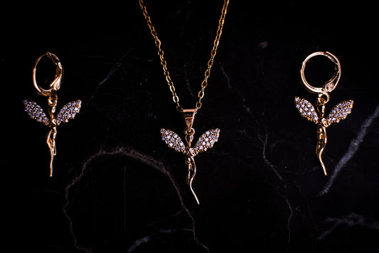 three pieces of jewelry on a black surface