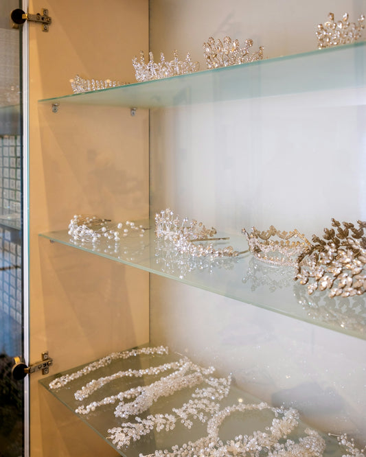a glass shelf filled with lots of silver items