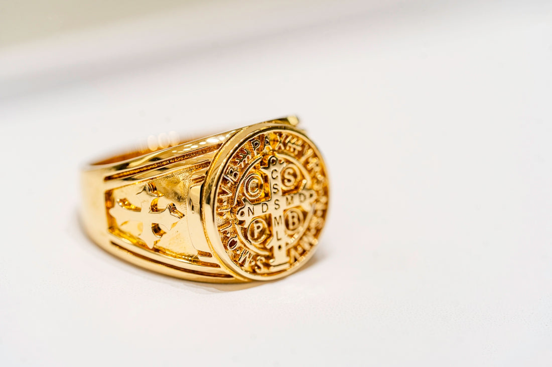a close up of a gold ring on a white surface