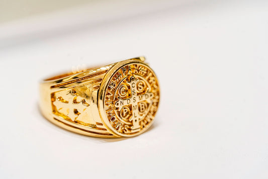a close up of a gold ring on a white surface