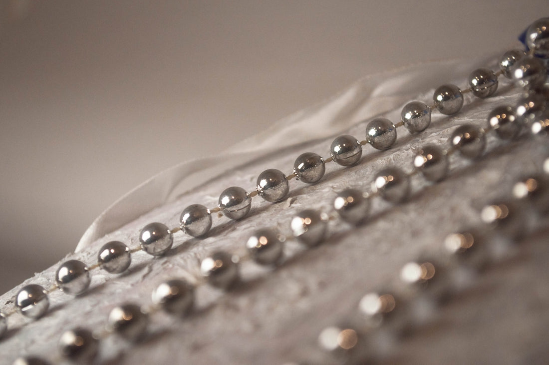 A close up of a metal object with beads on it