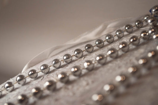 A close up of a metal object with beads on it